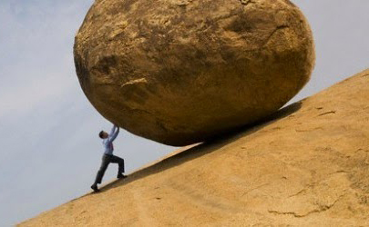 Person pushing rock up hill