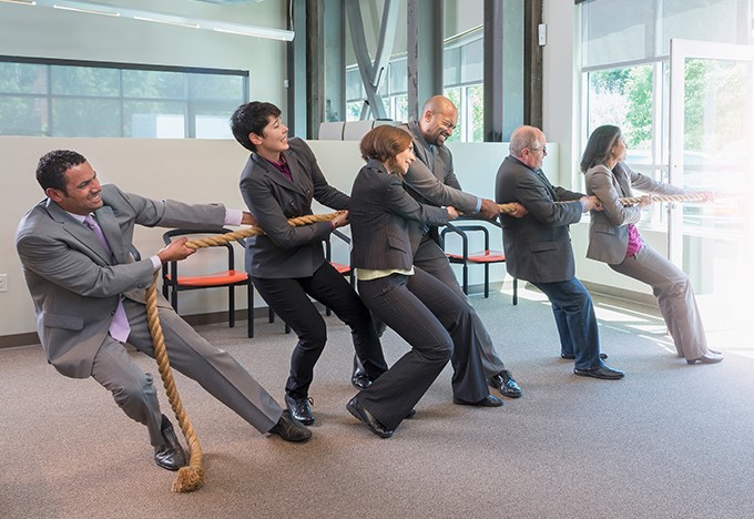 Office people playing tug-of-war