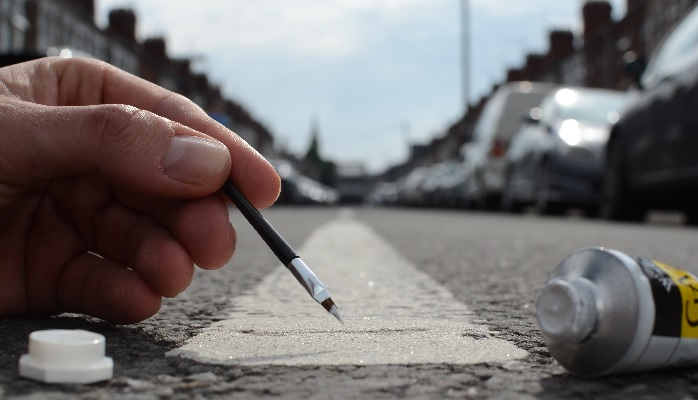 Hand painting a street stripe